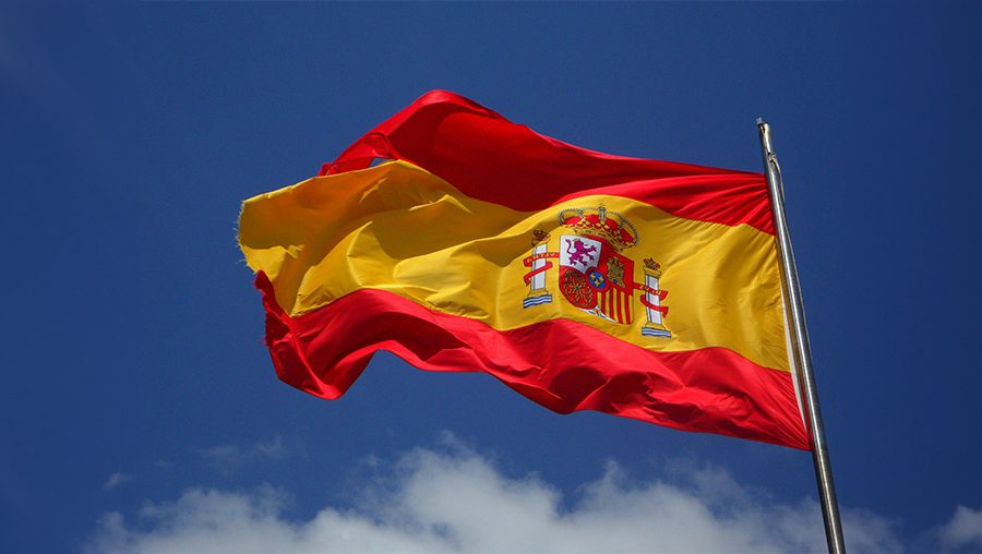 A picture of the Spanish flag waving in the wind